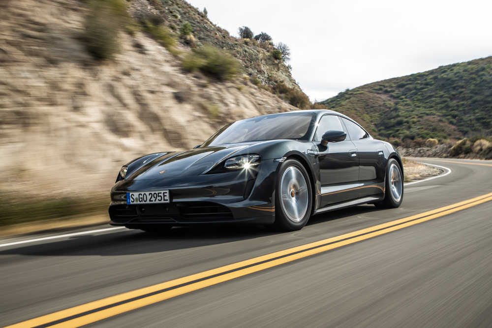 Black Porsche Taycan front and left side driving